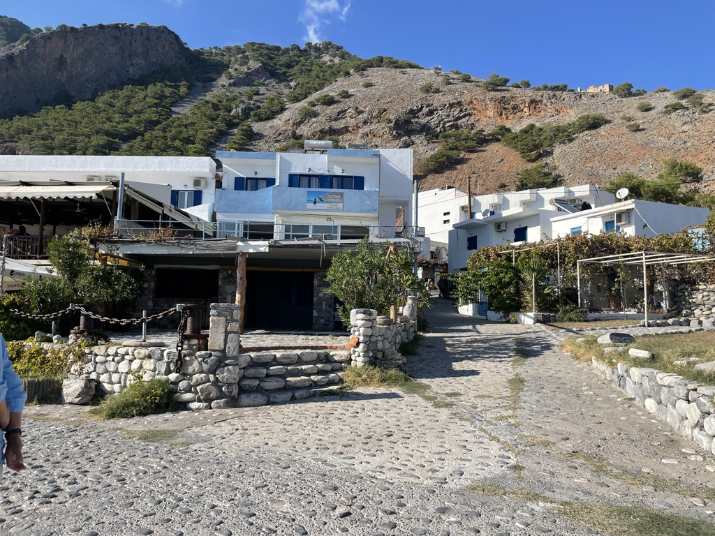 Some tourists walk up to the Turkish castle visible on the ridge at top right.
