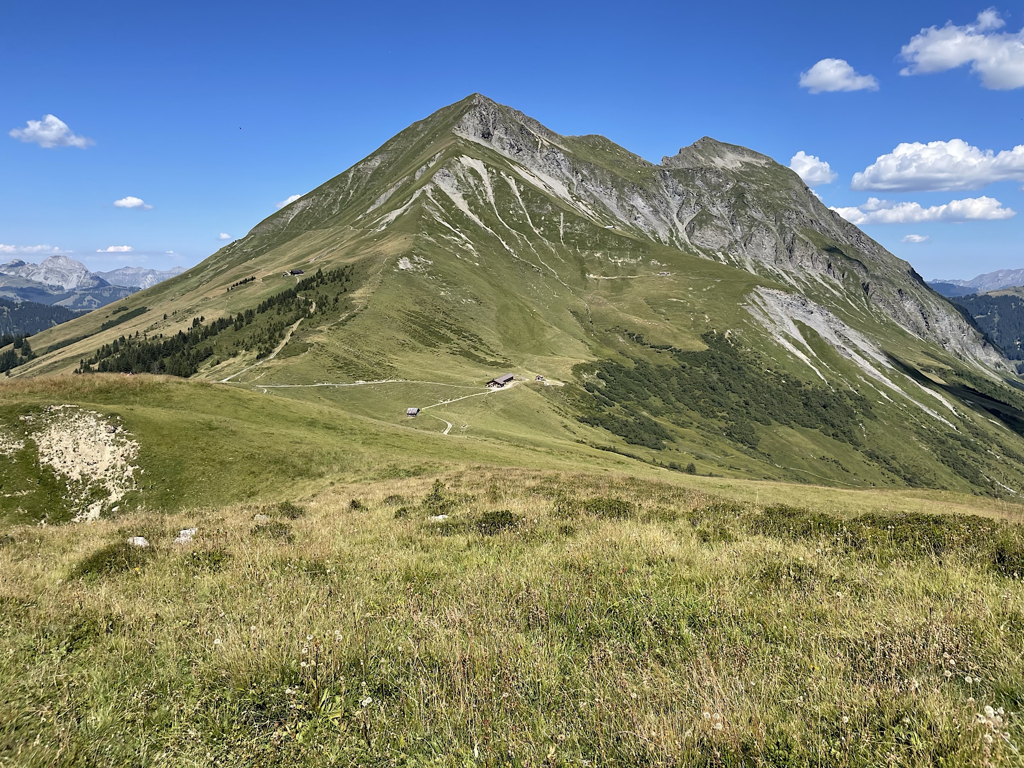 The trail runs to the right of this hill and down through the valley.
