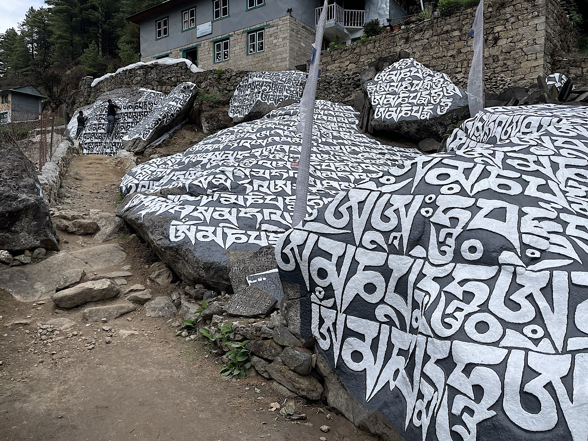 The monks had nearly finished painting the mantra stones that they’d been working on the last time we visited.