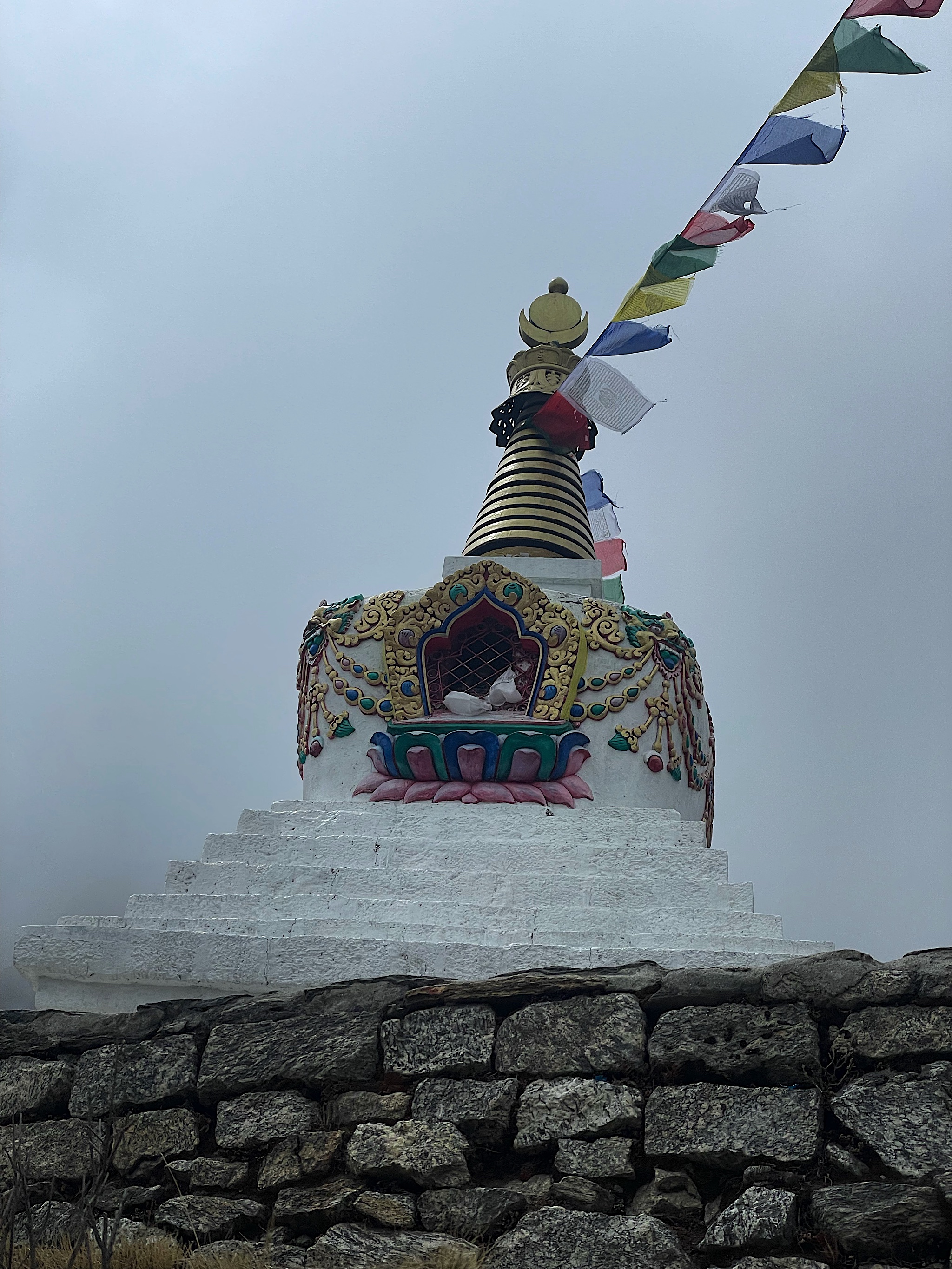 We passed the same stupa as before, this time socked in with clouds.